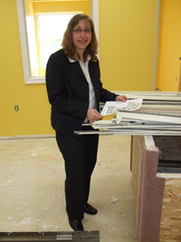 Scribendi.com President, Chandra Clarke, is surveying construction plans on the site of the new company offices.