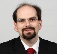 A headshot of Scribendi.com vice-president Terence Johnson. He is wearing a suit and glasses. 
