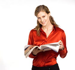 A young publisher is wearing a red shirt and holding a book.
